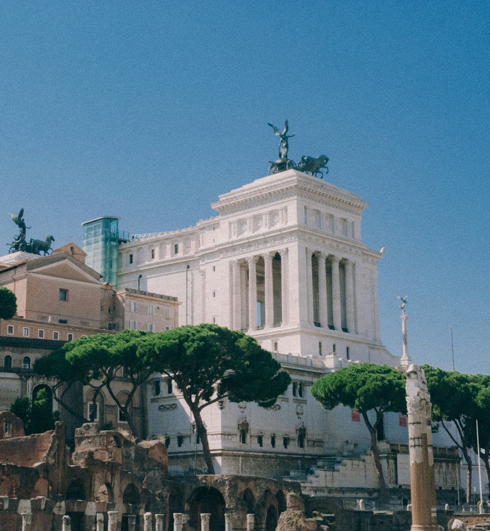 a large white building with a statue on top of it