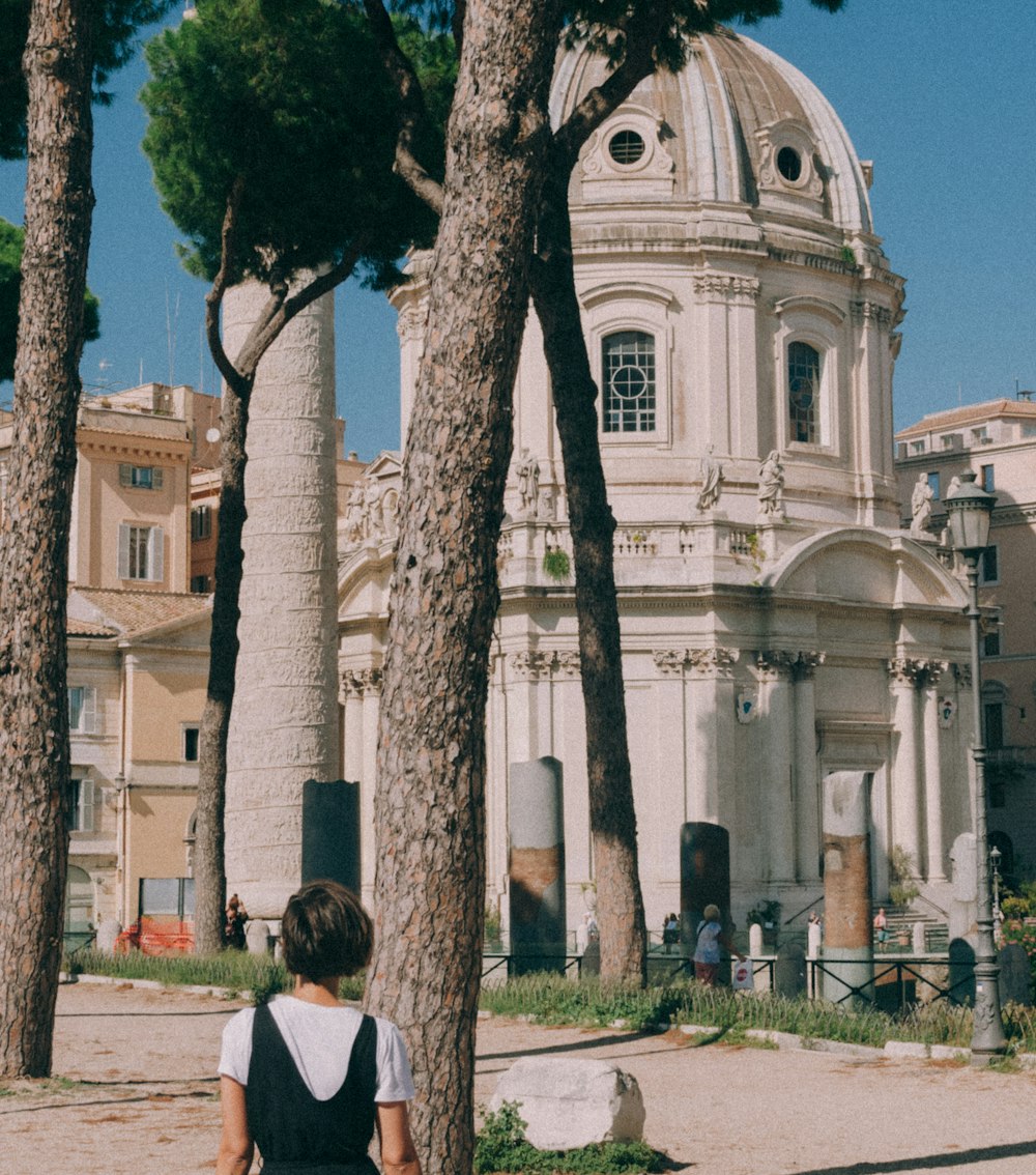 a person standing in front of some trees