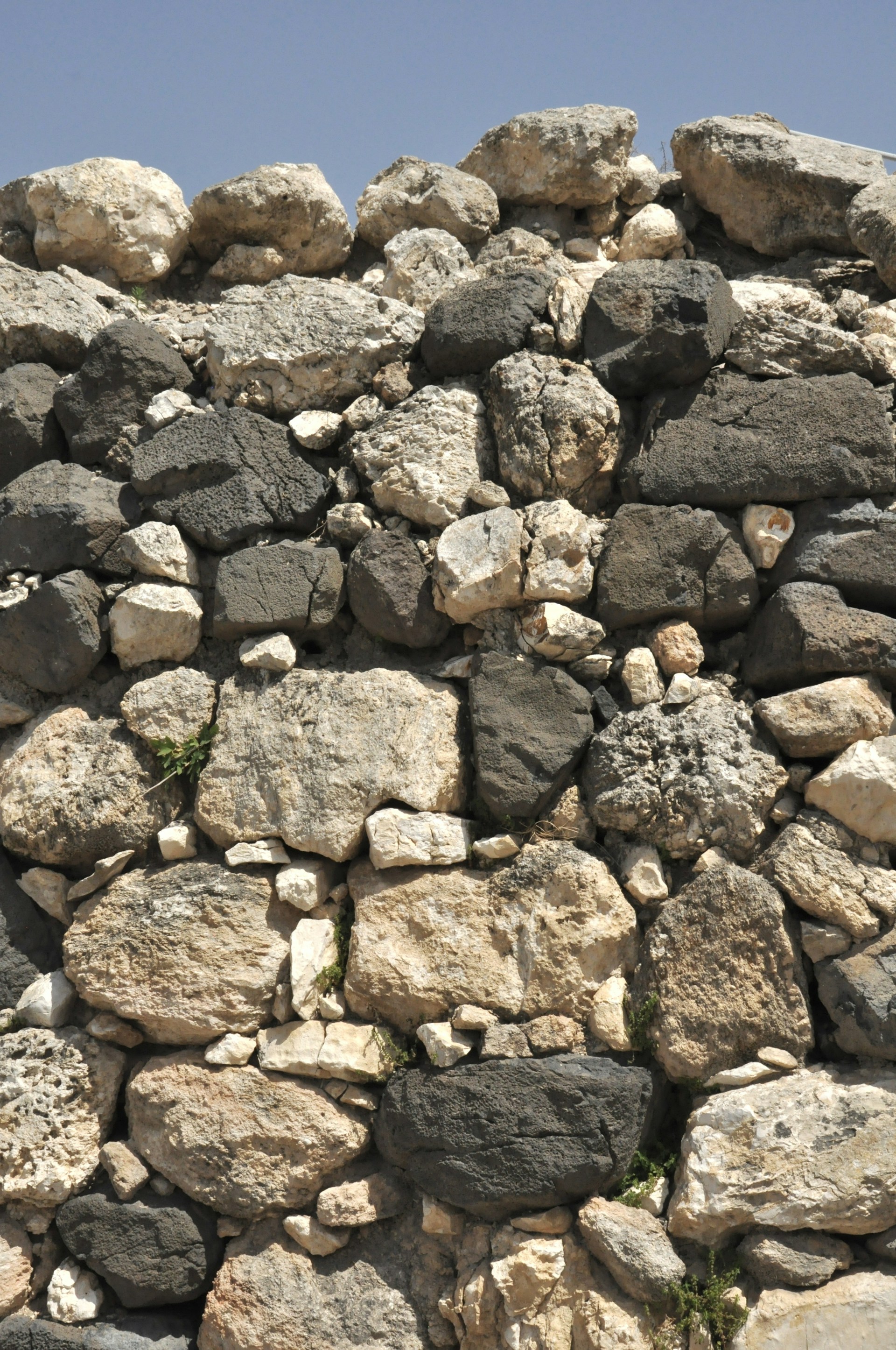 a large pile of rocks with a sky background
