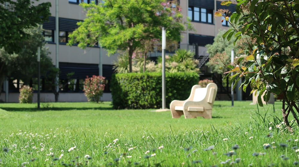 a park bench sitting in the middle of a lush green park