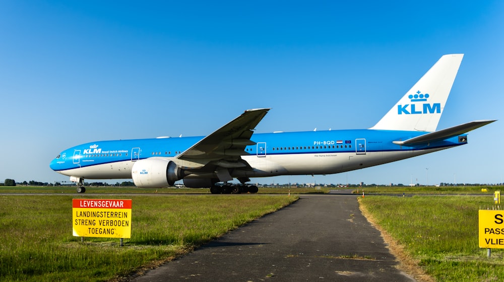 a large blue and white airplane on a runway