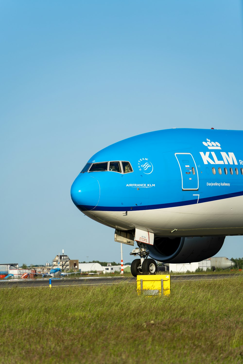 a large blue and white airplane on a runway