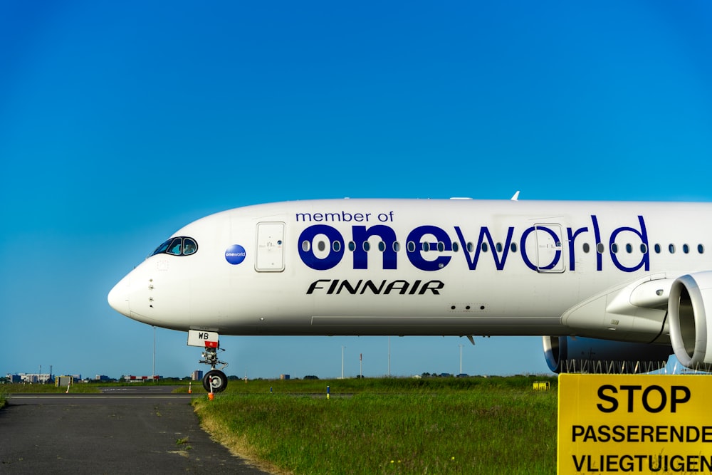 a large white plane sitting on top of an airport runway