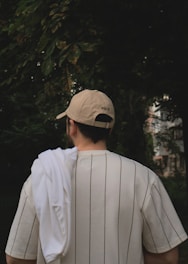 a man wearing a baseball cap and a white shirt