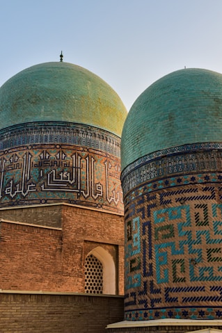 a couple of green and blue domes on top of a building