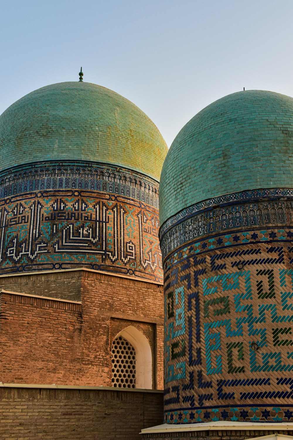 a couple of green and blue domes on top of a building