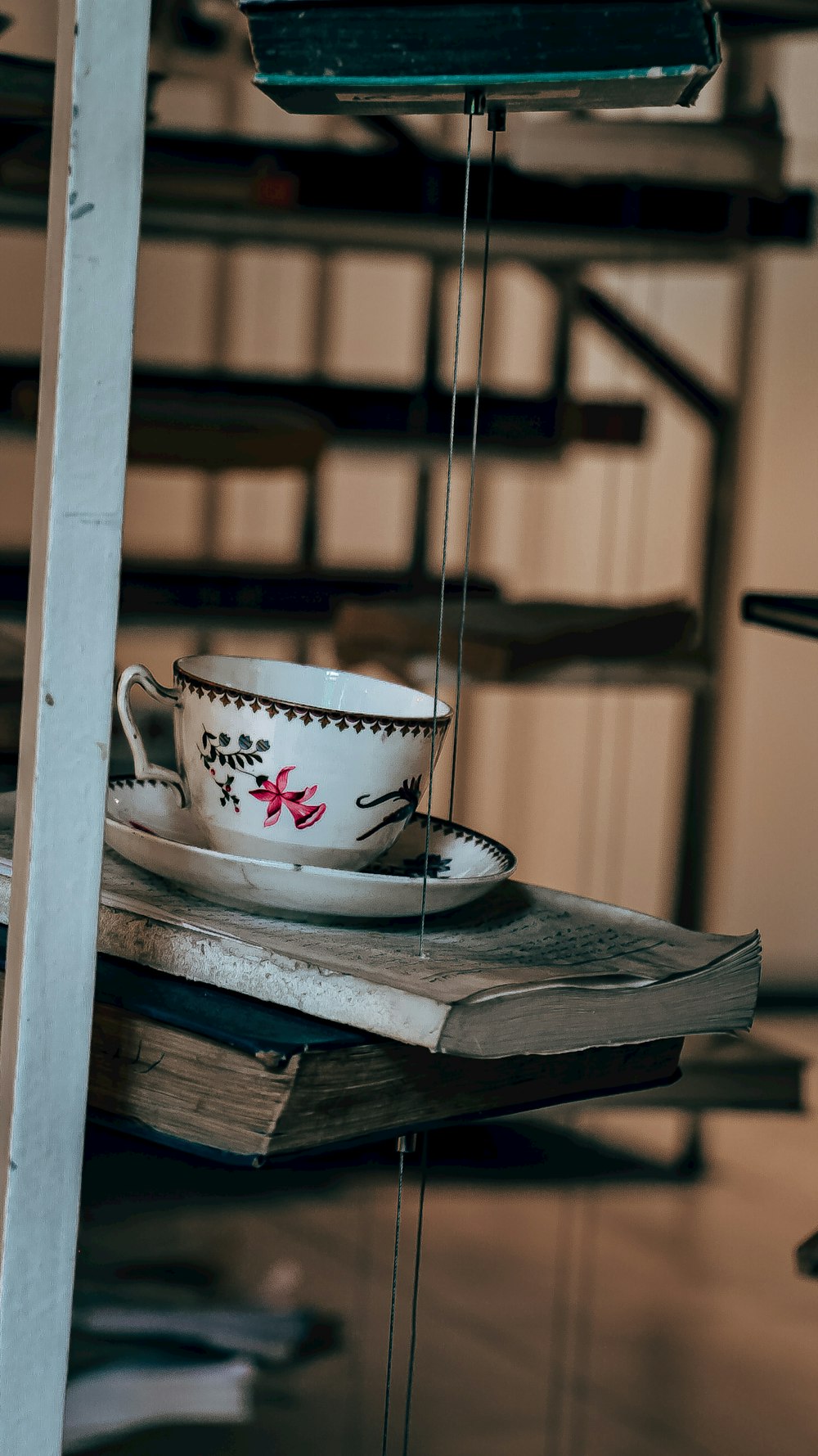 a tea cup on a table with a book