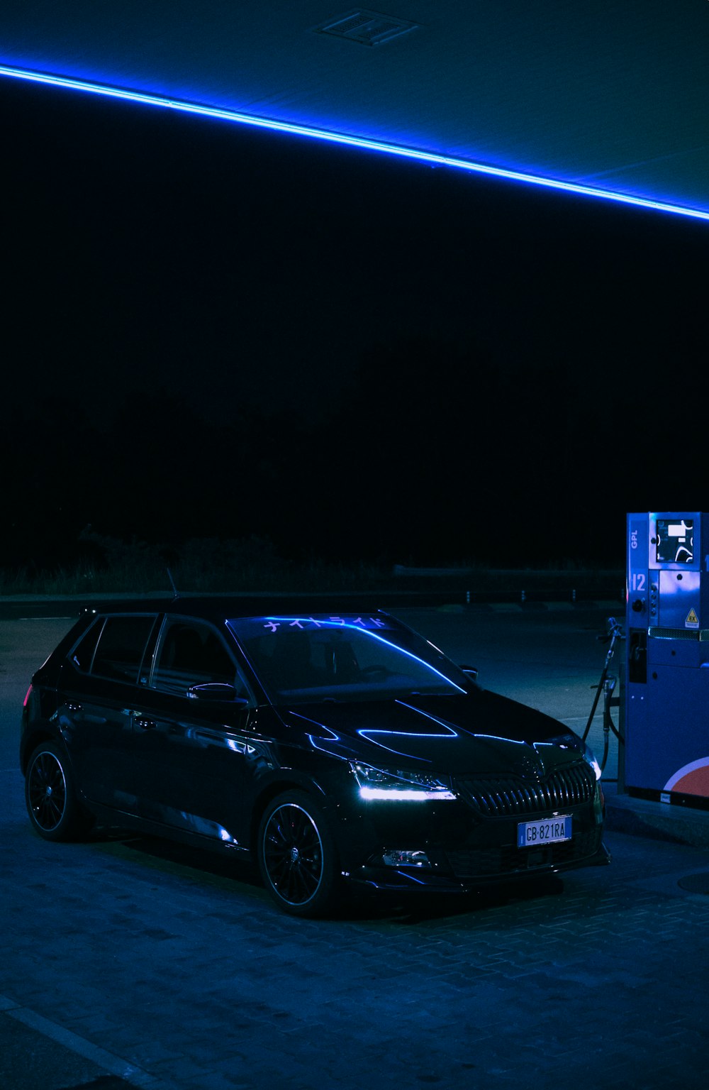 a car parked in a parking lot at night