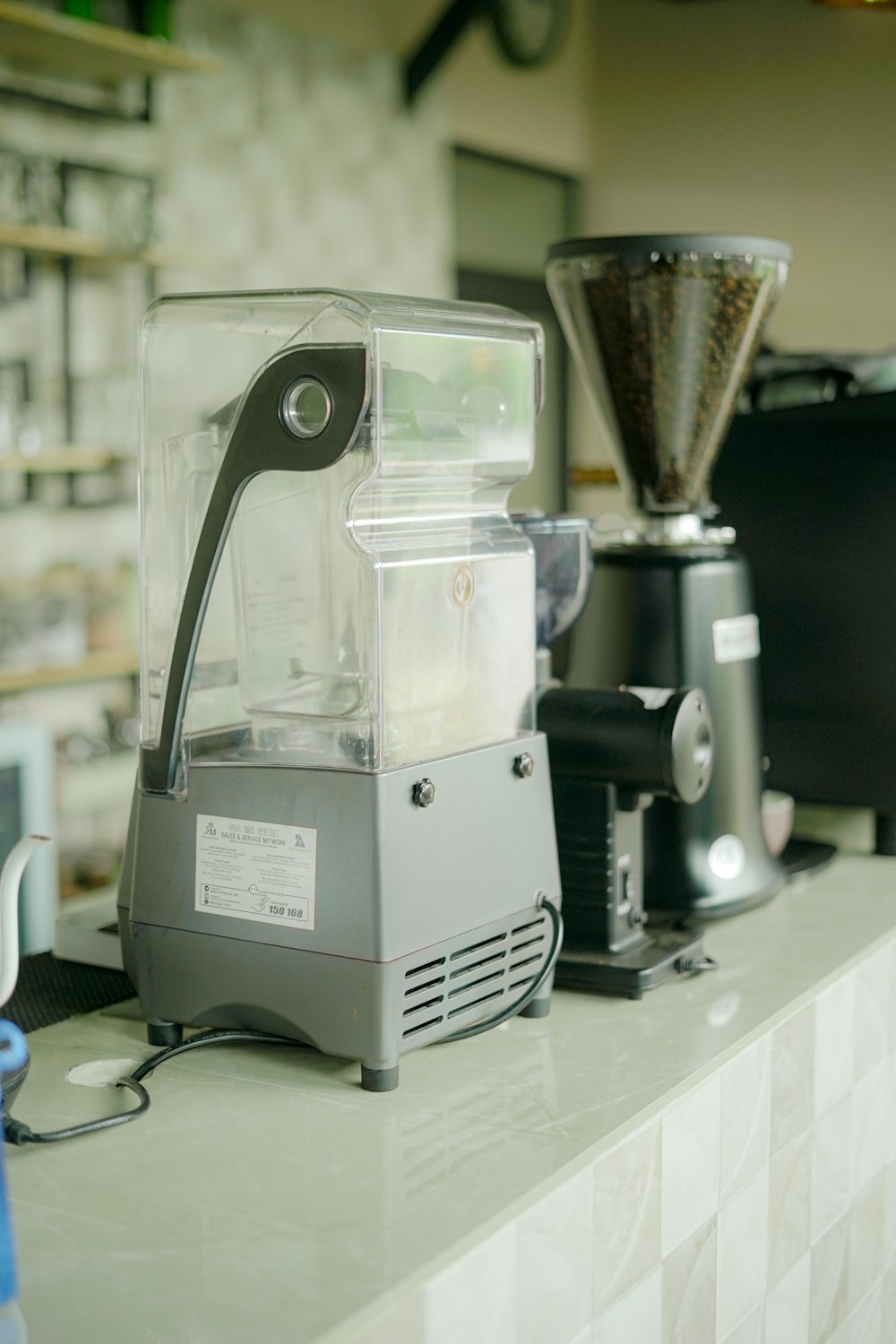 a blender sitting on top of a counter next to a blender