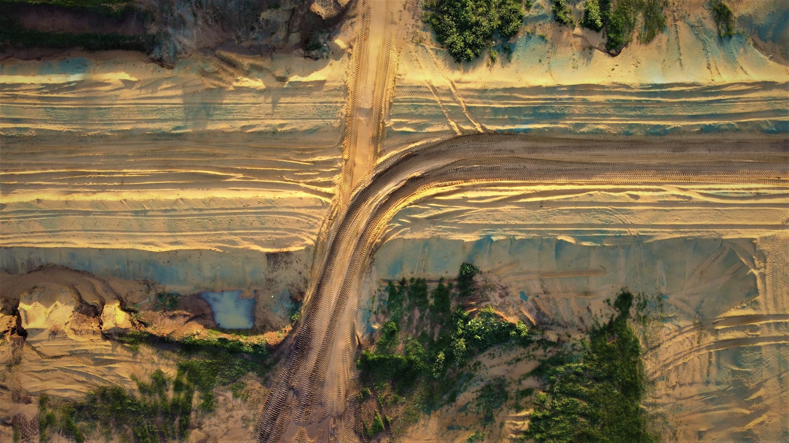 Aerial view of a dirt trail through mountain terrain