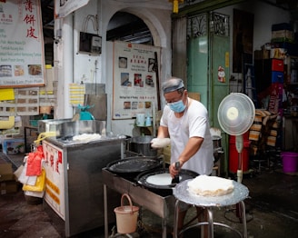 a man wearing a face mask is making food