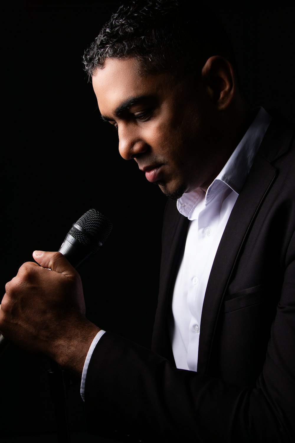 a man in a suit holding a microphone