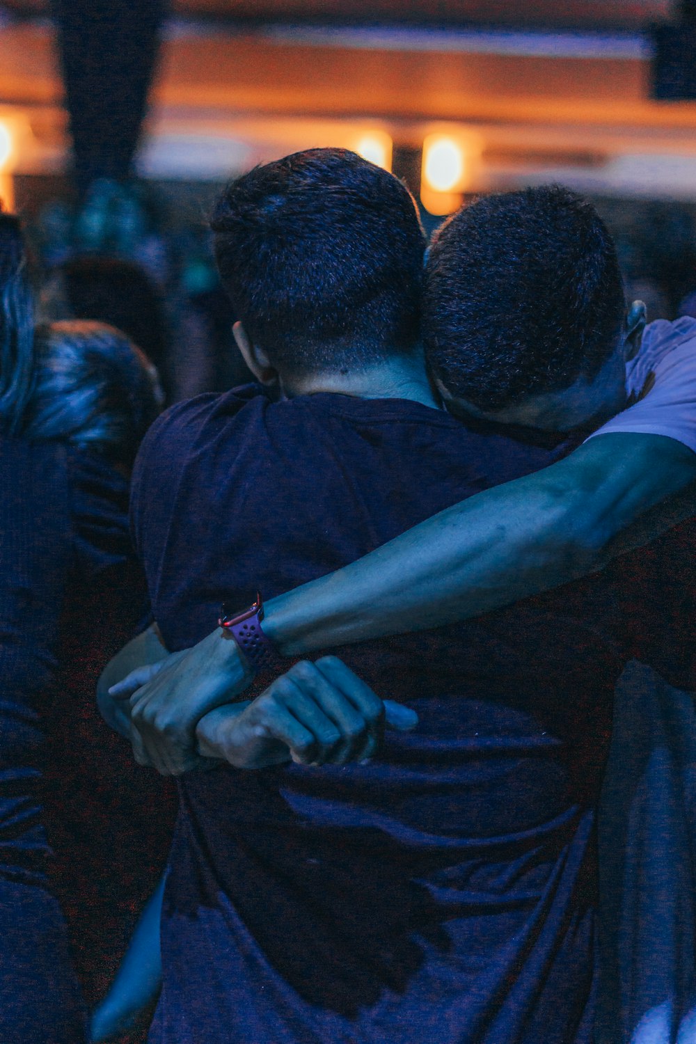 a couple of people hugging each other in a room