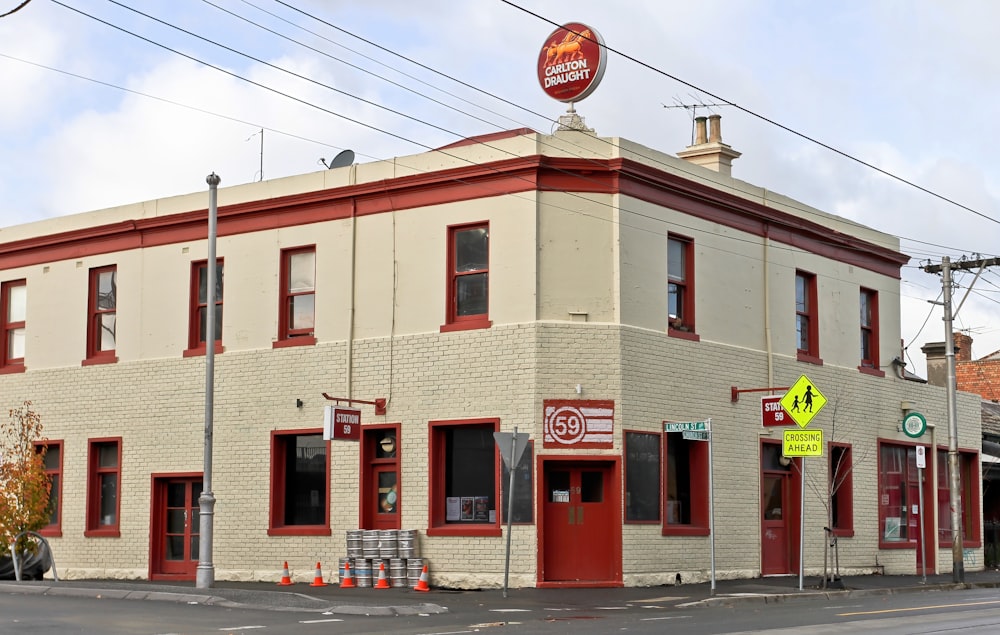 a red and white building sitting on the side of a road