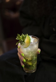 a close up of a person holding a drink
