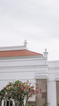 a white building with a clock on the front of it