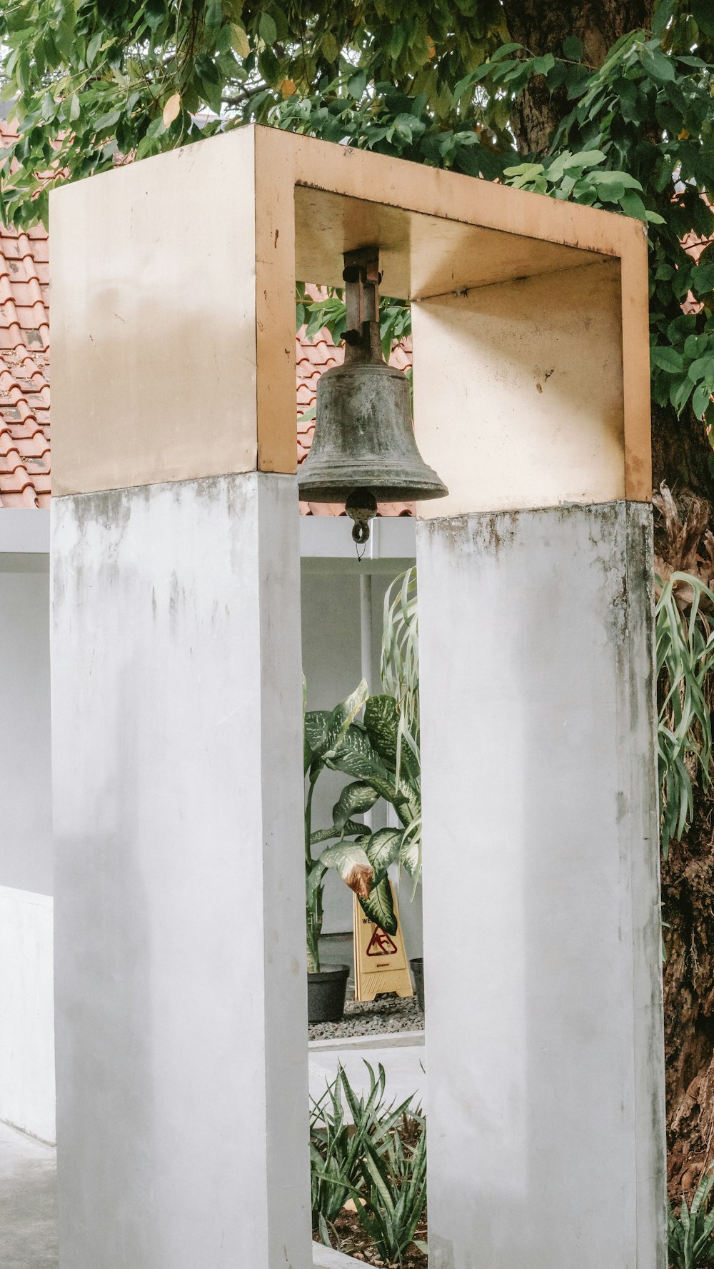 a bell on top of a cement structure