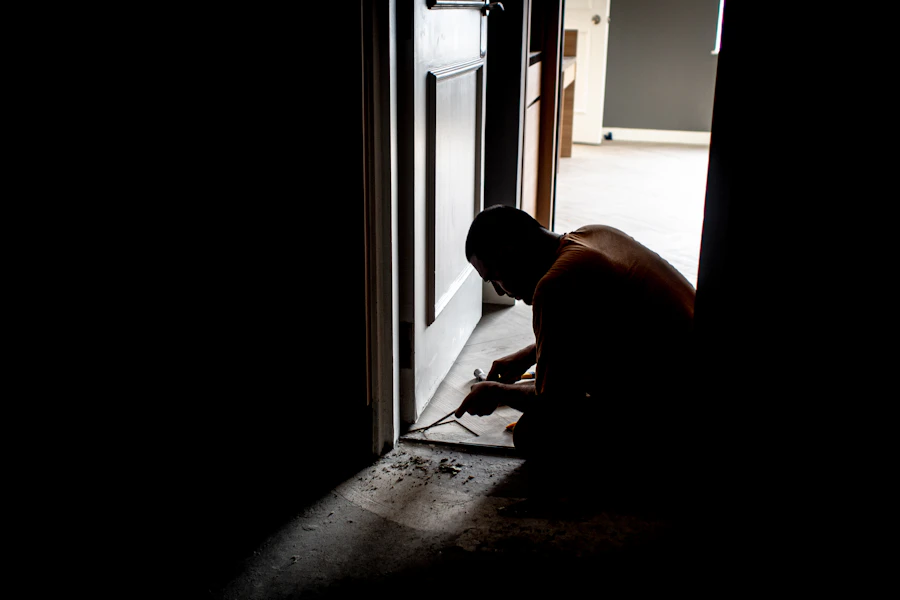 Worker kneeling at a doorway during a home renovation