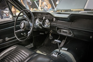 the interior of a car with a steering wheel and dashboard