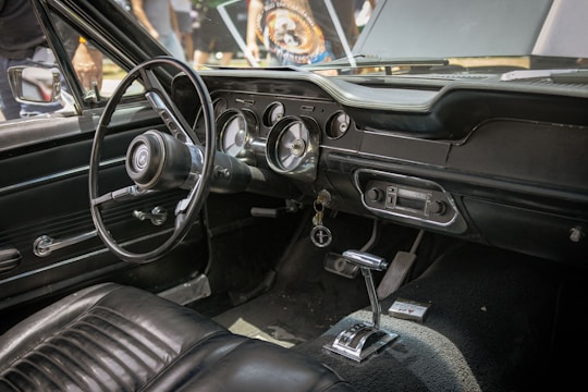 the interior of a car with a steering wheel and dashboard