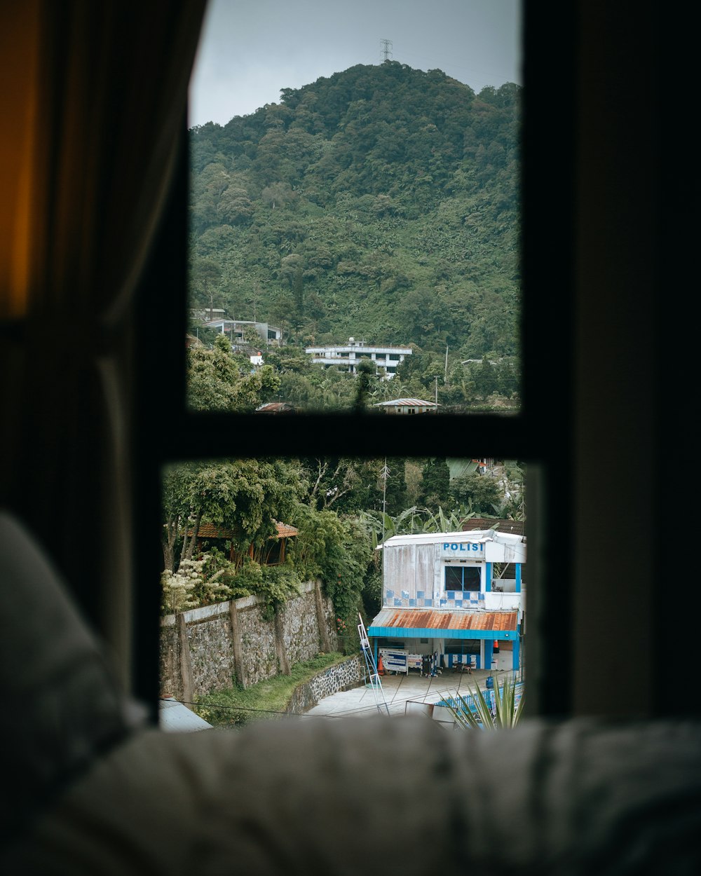 a view of a mountain from a bedroom window