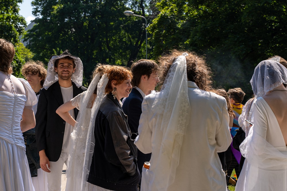 a group of people standing around each other