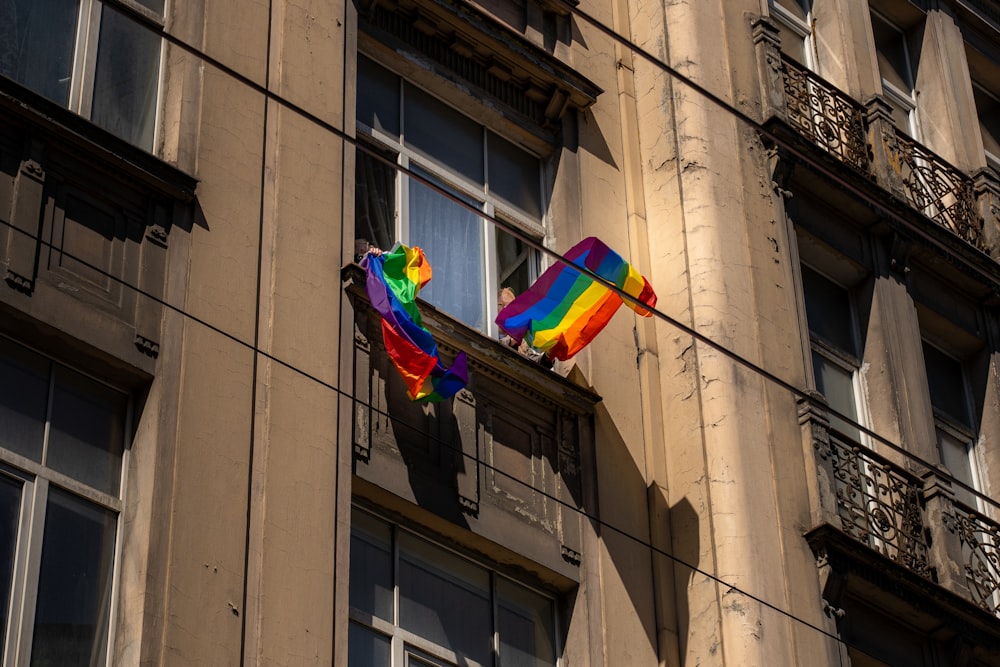 a colorful kite hanging from the side of a building