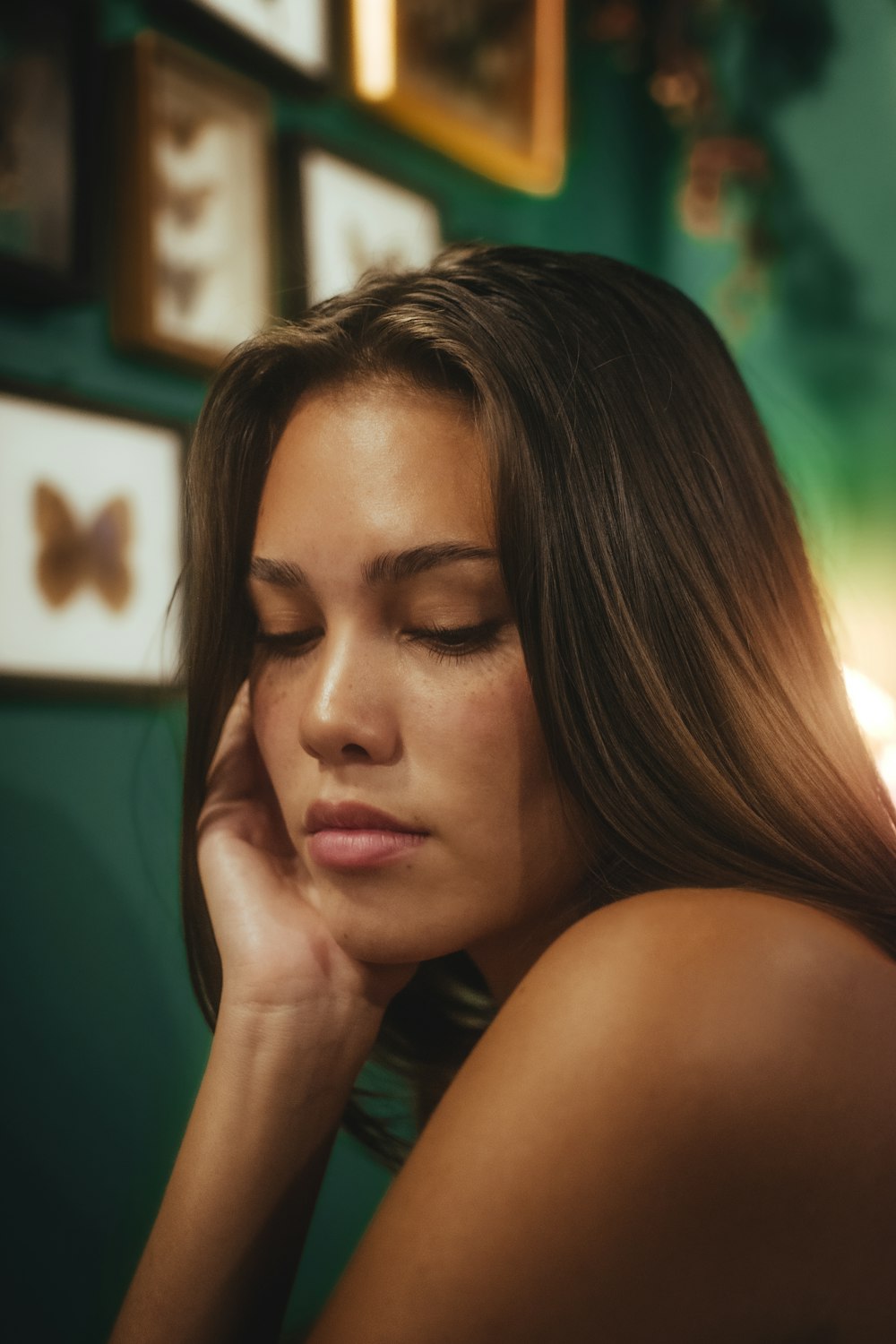 a woman with long hair sitting in a room