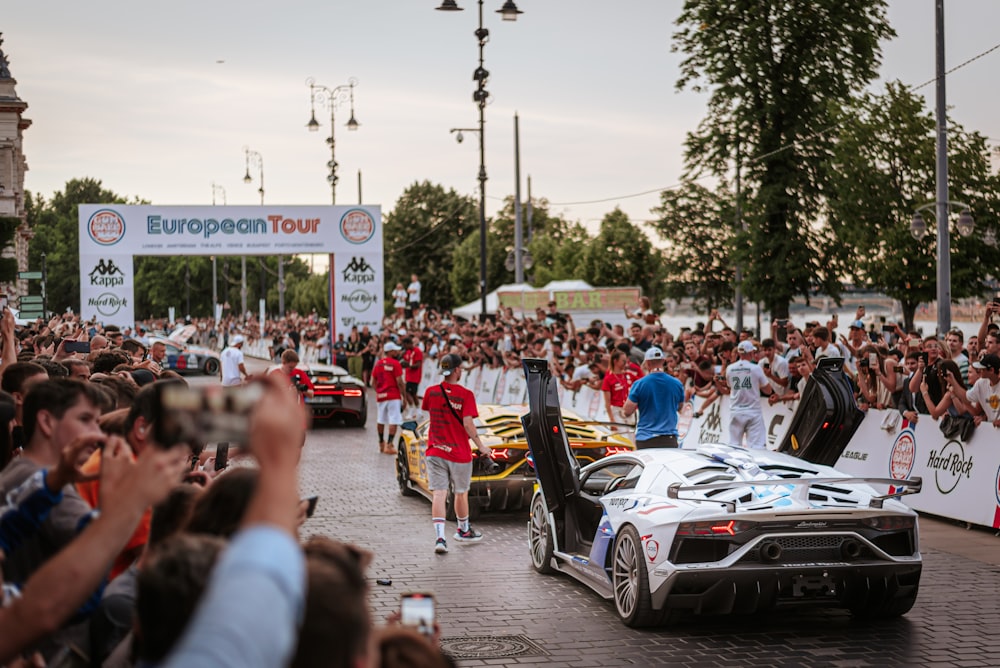 a group of people standing around a race car