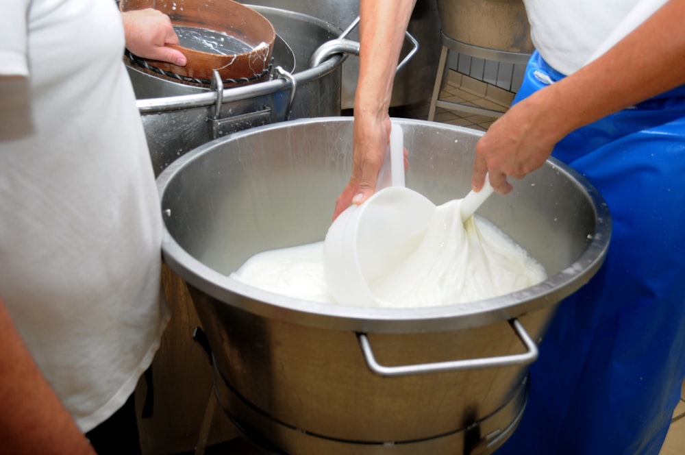 a person mixing something in a large pot