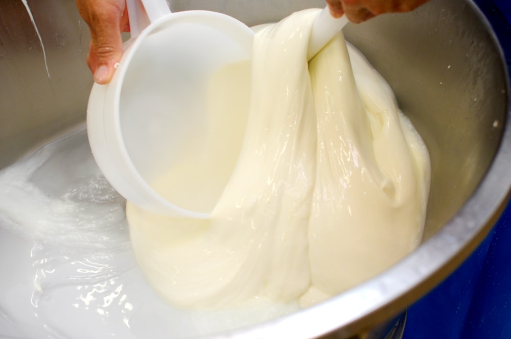 a person is mixing a mixture in a bowl