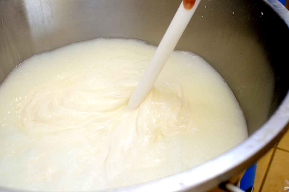 a bowl of milk with a spoon in it