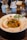Overhead view of a beautifully plated pasta dish with fresh herbs and vibrant sauce.
