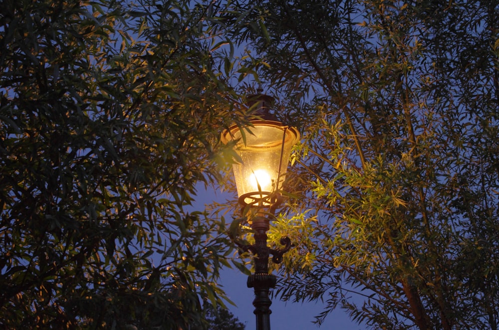 a street light is lit up in the night
