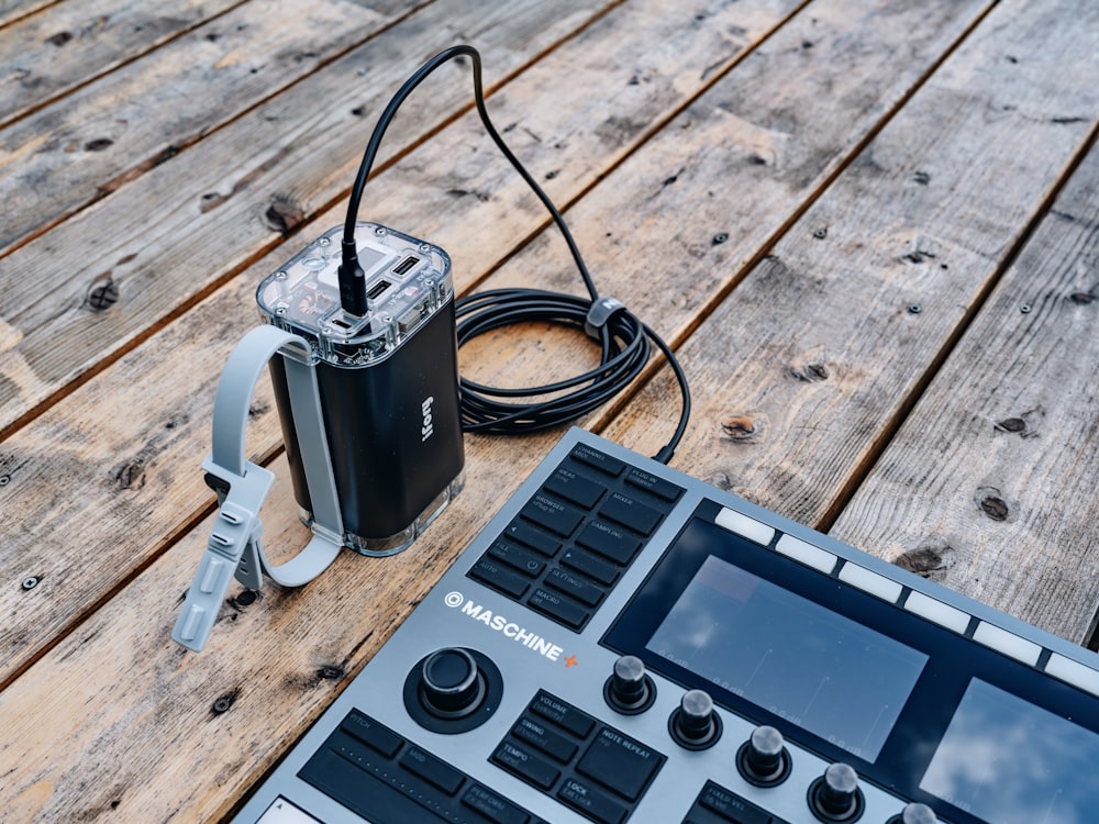 an electronic device sitting on top of a wooden table