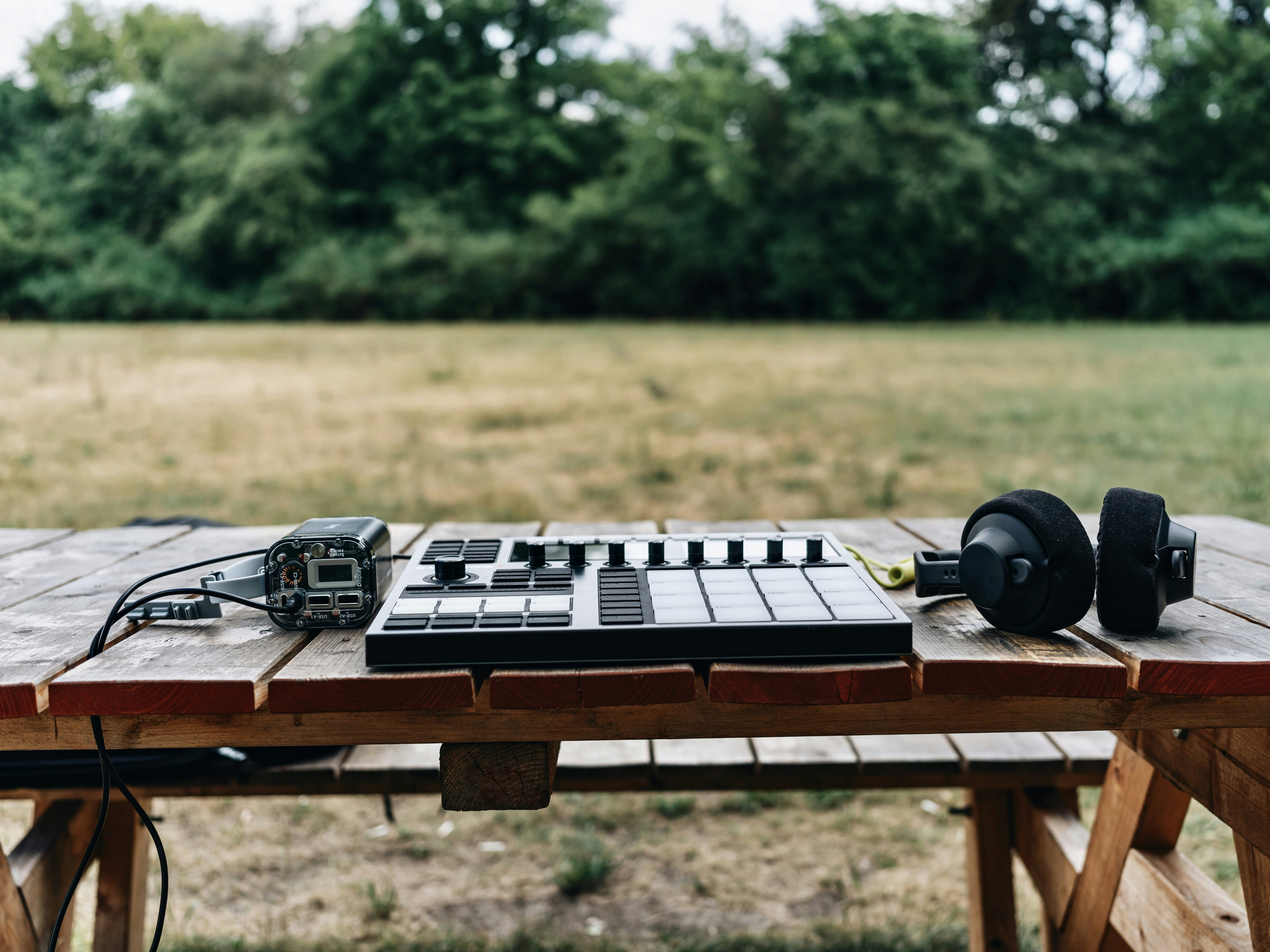a table with a keyboard and headphones on it
