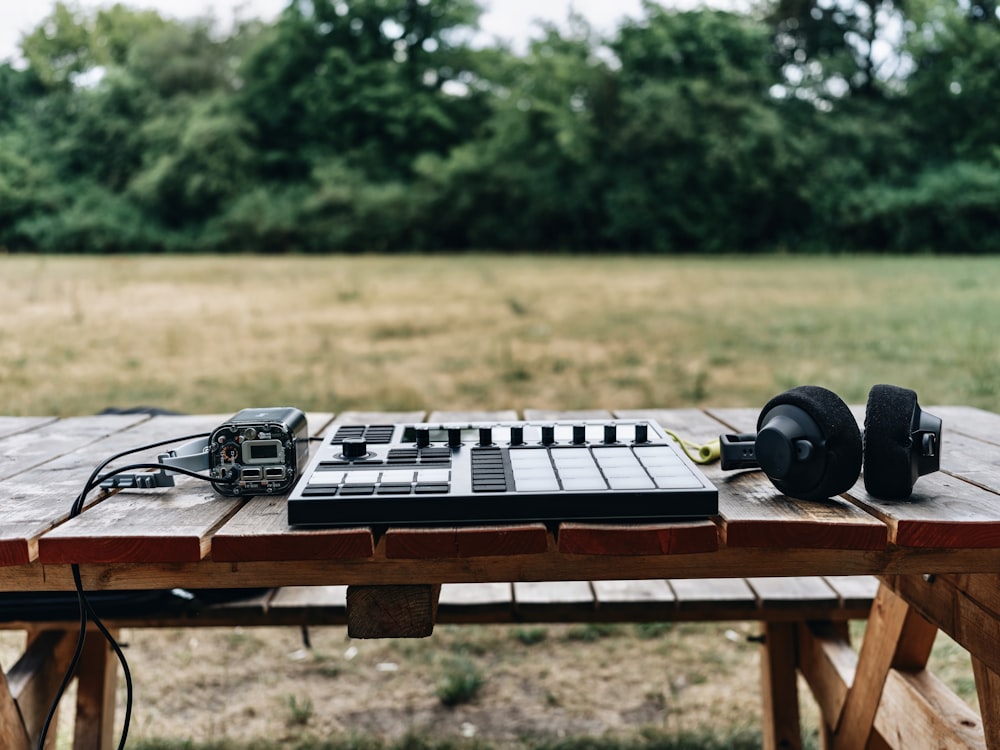 a table with a keyboard and headphones on it