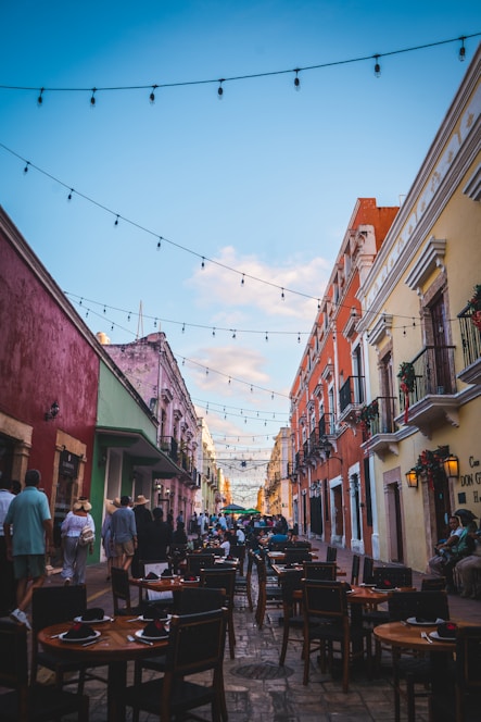 A lively street scene in Belo Horizonte with colorful restaurants and happy people dining outdoors.