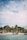 A lively beach scene with several people gathered near the shore, next to thatched-roof huts and lush palm trees. Boats are anchored near the water, and the sky is partially cloudy with sunlight filtering through.