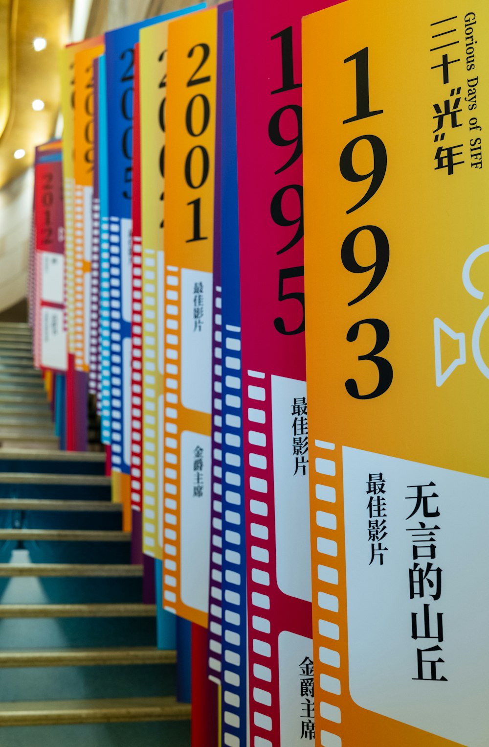 a row of colorful signs on the side of a building