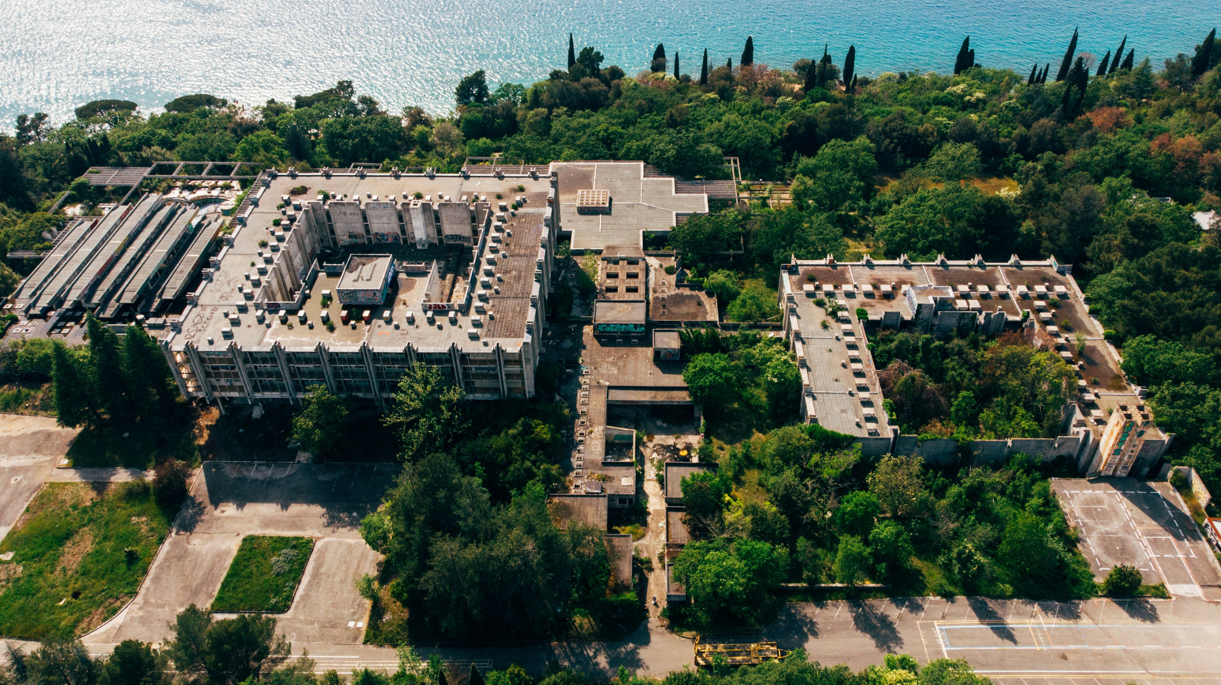an aerial view of a building surrounded by trees