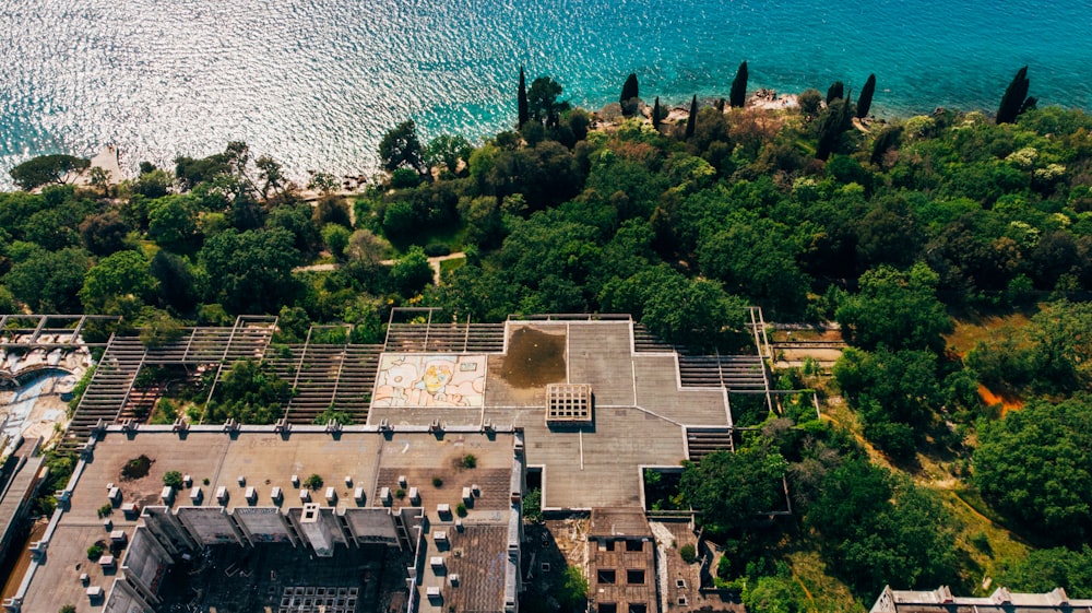 an aerial view of a building near a body of water