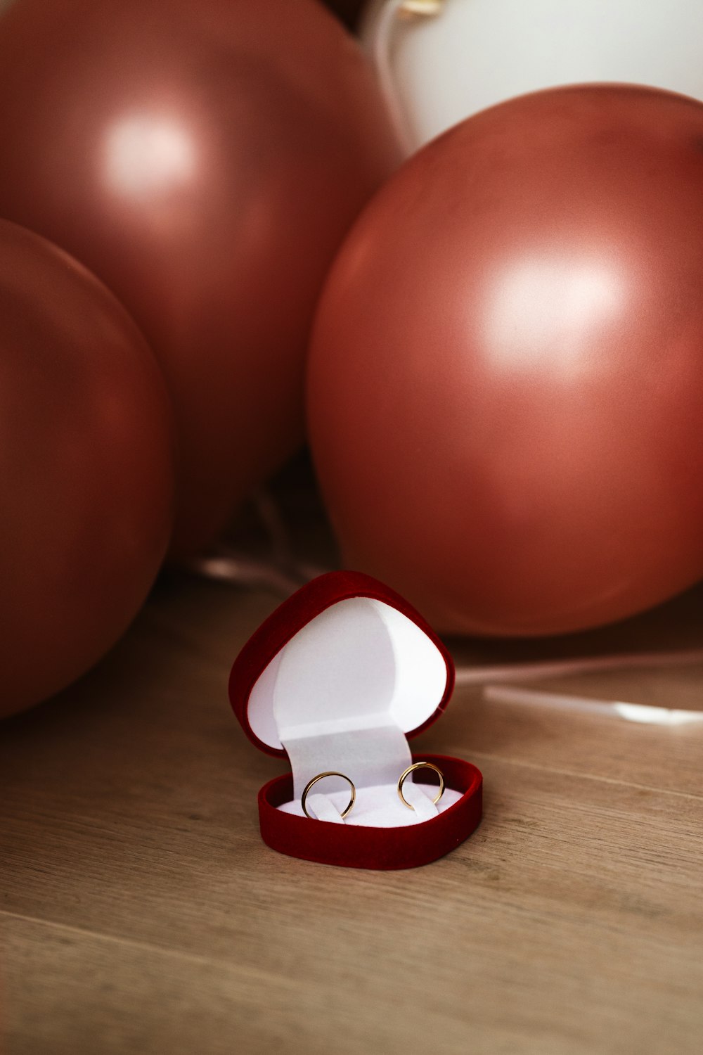 an open ring box sitting on top of a wooden table