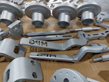 An assortment of finished CNC parts laid out, showcasing varied shapes and polished finishes.