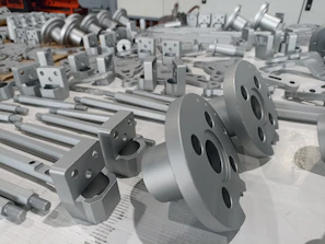 Shiny chrome-coated metal parts arranged neatly on a workshop bench