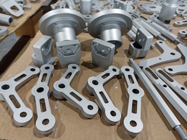 An array of finished metal parts displayed on a workbench, highlighting craftsmanship.