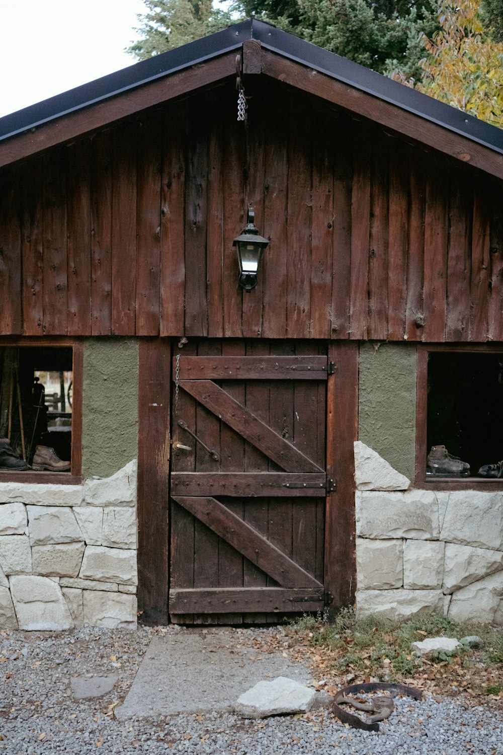 a barn with a wooden door and windows