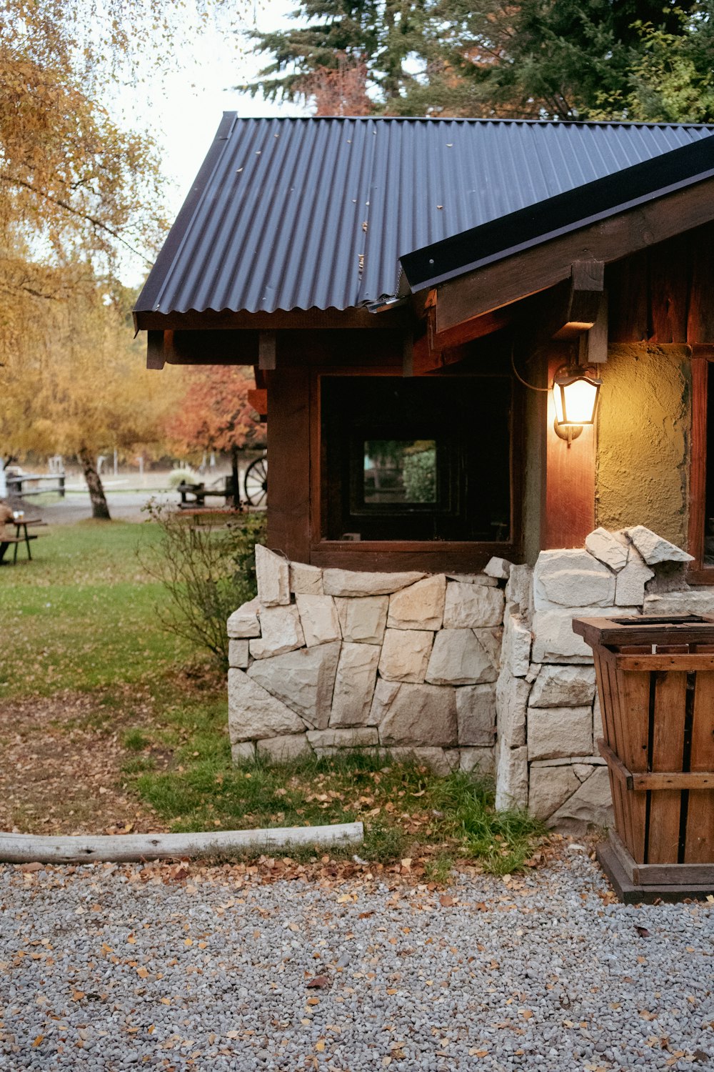 a small stone building with a metal roof