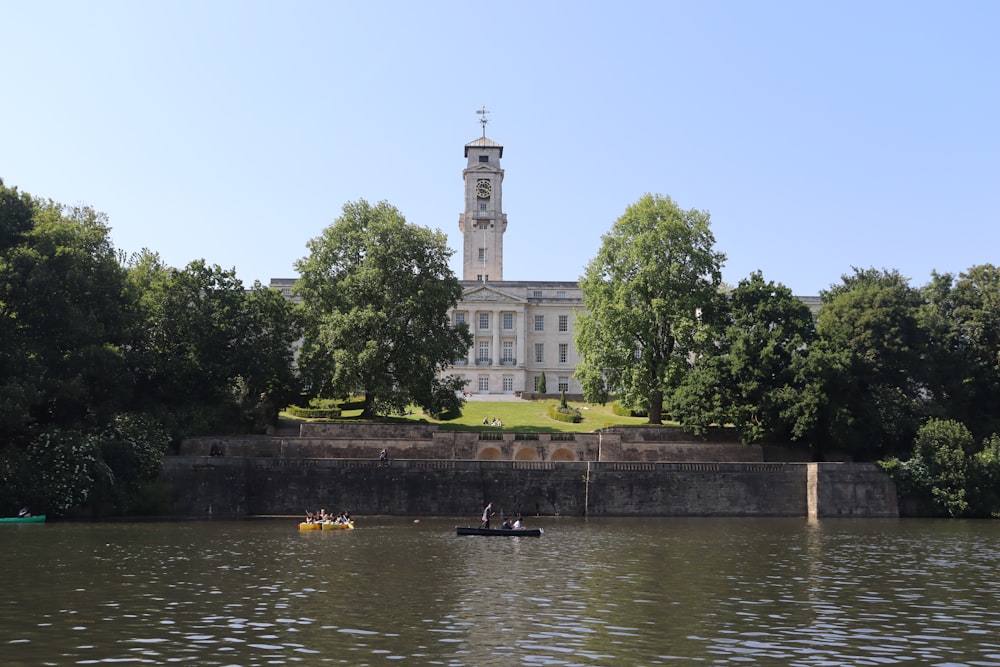 a large building sitting on top of a lush green hillside