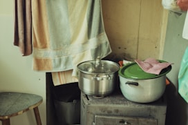 a stove top oven sitting next to a pot on top of a wooden table